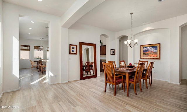 dining area with a chandelier and light hardwood / wood-style floors