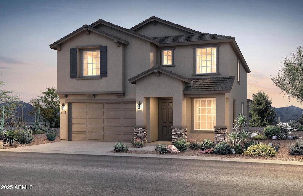 front facade with a mountain view and a garage