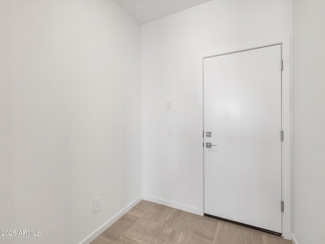 empty room featuring baseboards