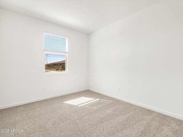 carpeted empty room with baseboards