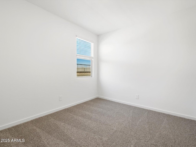 empty room with baseboards and carpet floors