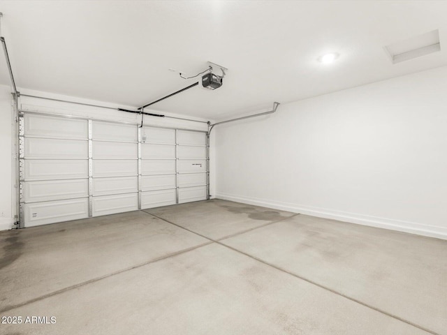 garage with a garage door opener and baseboards