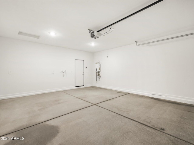 garage featuring water heater, recessed lighting, a garage door opener, and baseboards