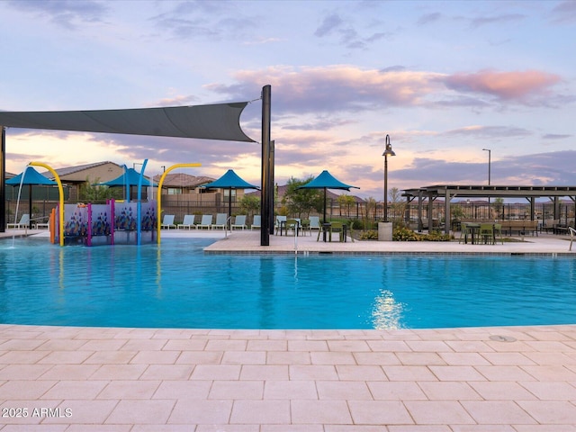 view of swimming pool featuring a patio area and fence