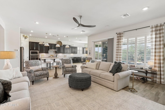14204 S 179th Ln, Goodyear, AZ 85338 - living room with light wood-style flooring, a ceiling fan, visible vents, and recessed lighting