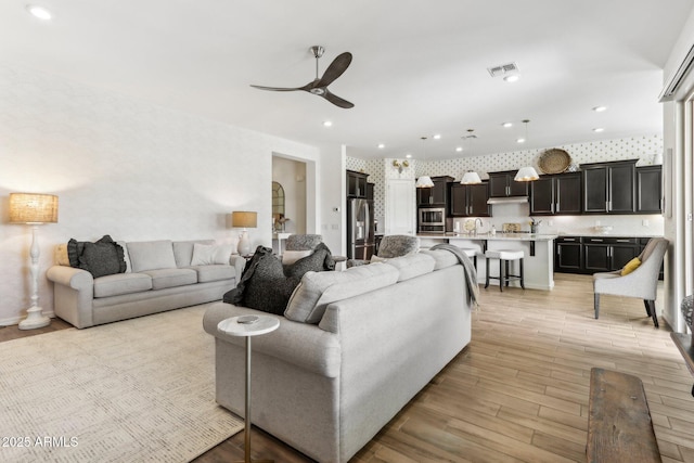 14204 S 179th Ln, Goodyear, AZ 85338 - living room with visible vents, ceiling fan, light wood-type flooring, and recessed lighting