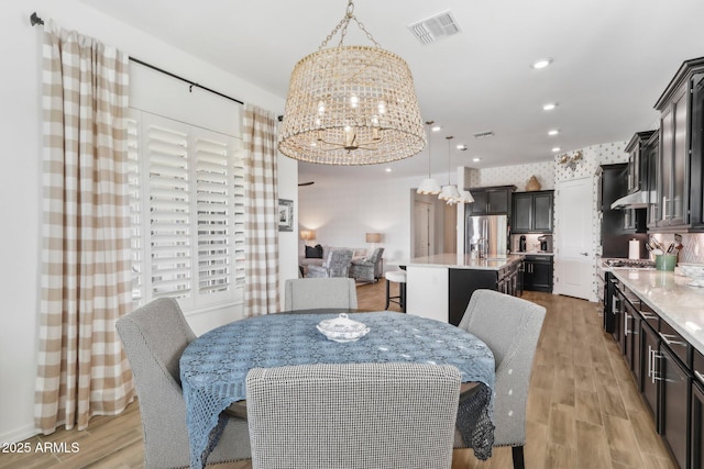 14204 S 179th Ln, Goodyear, AZ 85338 - dining room featuring a chandelier, light wood finished floors, visible vents, and recessed lighting