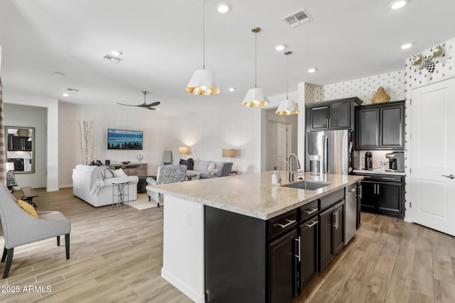 14204 S 179th Ln, Goodyear, AZ 85338 - kitchen with stainless steel appliances, visible vents, a sink, and light wood-style flooring
