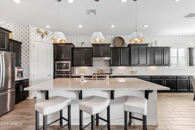 14204 S 179th Ln, Goodyear, AZ 85338 - kitchen featuring stainless steel appliances, visible vents, a sink, and wallpapered walls