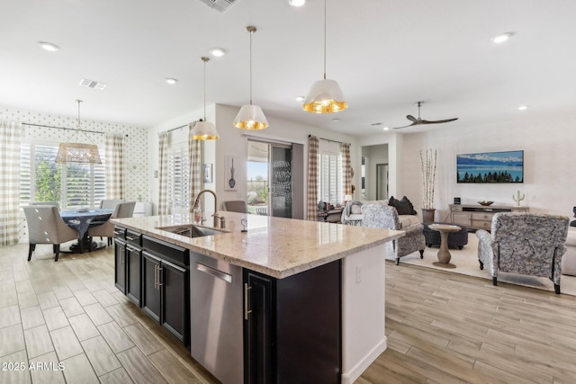 14204 S 179th Ln, Goodyear, AZ 85338 - kitchen featuring visible vents, dishwasher, a sink, open floor plan, and light wood-style floors