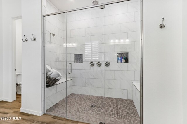 14204 S 179th Ln, Goodyear, AZ 85338 - full bathroom with toilet, a shower stall, wood finished floors, and baseboards