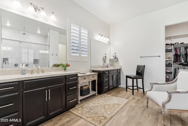 14204 S 179th Ln, Goodyear, AZ 85338 - full bathroom featuring a stall shower, wood finished floors, and vanity