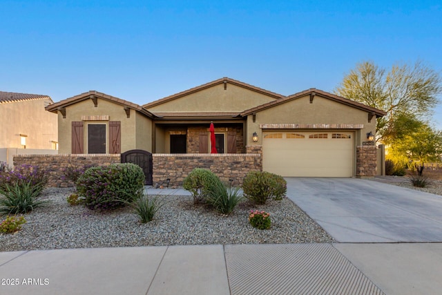 14204 S 179th Ln, Goodyear, AZ 85338 - view of front of home with an attached garage, stone siding, fence, concrete driveway, and stucco siding