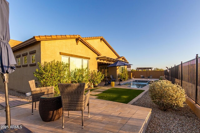 14204 S 179th Ln, Goodyear, AZ 85338 - back of property with a tiled roof, a patio area, stucco siding, and a fenced backyard