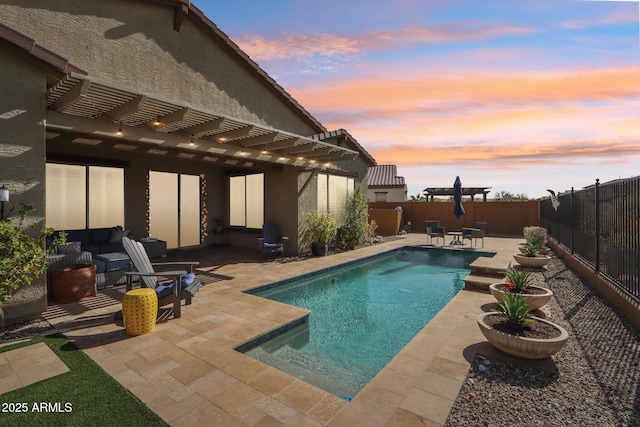 14204 S 179th Ln, Goodyear, AZ 85338 - pool at dusk with a fenced backyard, a fenced in pool, a patio, and a pergola