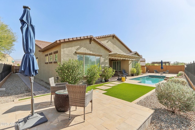 14204 S 179th Ln, Goodyear, AZ 85338 - back of house featuring a pergola, a fenced backyard, a patio, stucco siding, and a fenced in pool