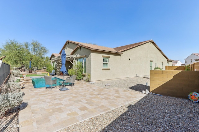 14204 S 179th Ln, Goodyear, AZ 85338 - back of property featuring a fenced in pool, a patio, stucco siding, a fenced backyard, and a tiled roof