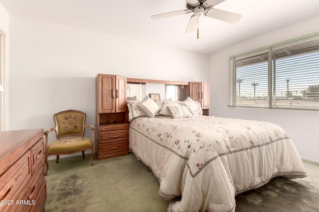 bedroom with ceiling fan and dark colored carpet