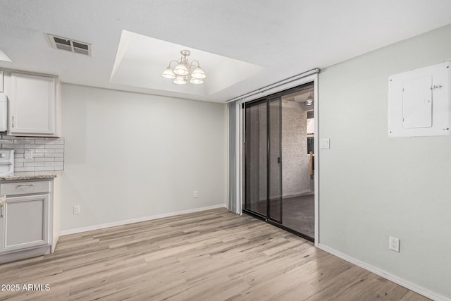 234 N 75th St Unit 209, Mesa, AZ 85207 - unfurnished dining area with electric panel, light wood-style flooring, baseboards, and a chandelier