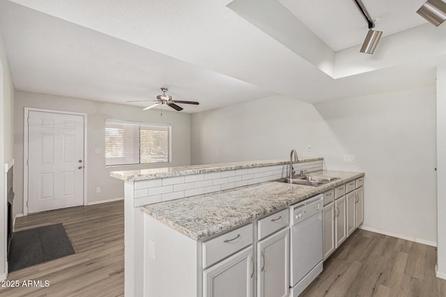 234 N 75th St Unit 209, Mesa, AZ 85207 - kitchen featuring dishwasher, a sink, a peninsula, baseboards, and a ceiling fan