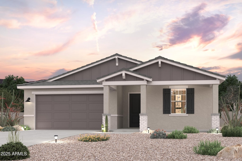 view of front of house with stucco siding, board and batten siding, concrete driveway, and an attached garage