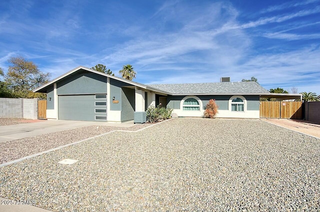 single story home with central AC and a garage