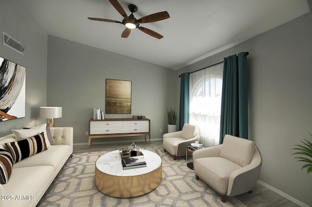 living room featuring ceiling fan, lofted ceiling, and light wood-type flooring