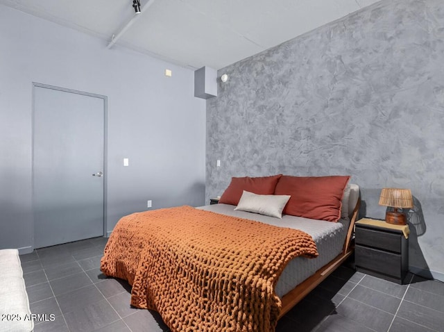 bedroom with dark tile patterned floors