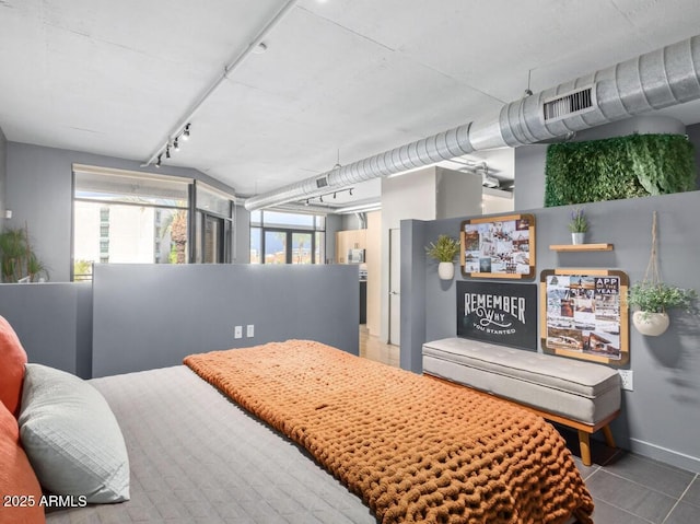 bedroom with tile patterned flooring and track lighting