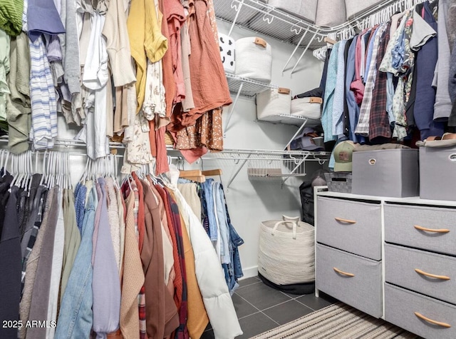 walk in closet featuring dark tile patterned floors