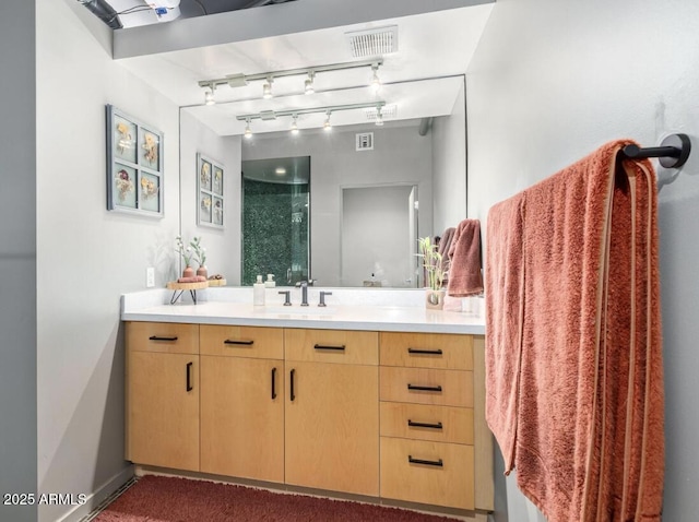 bathroom featuring an enclosed shower and vanity