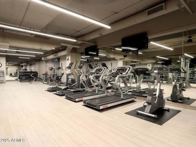 workout area with hardwood / wood-style floors