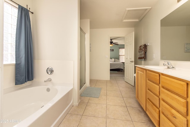 bathroom featuring independent shower and bath, vanity, a wealth of natural light, and tile patterned floors