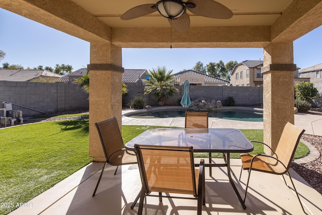 view of patio / terrace featuring a fenced in pool and ceiling fan