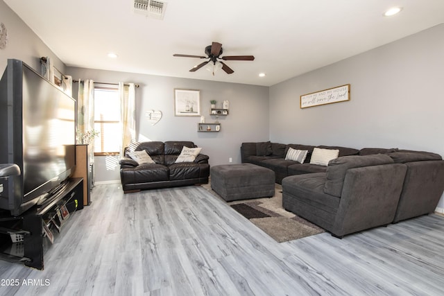 living room with ceiling fan and light hardwood / wood-style floors