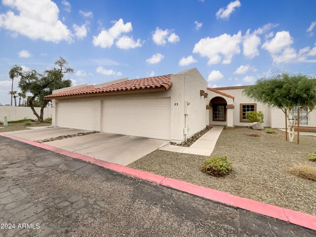 mediterranean / spanish home with a garage