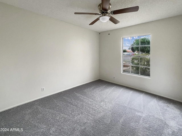 carpeted empty room featuring a textured ceiling, ceiling fan, and baseboards