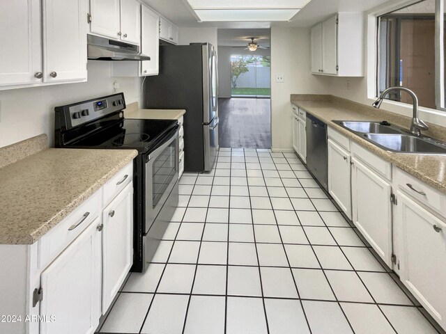 kitchen with appliances with stainless steel finishes, white cabinetry, sink, and ceiling fan