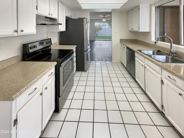 kitchen featuring under cabinet range hood, stainless steel appliances, a sink, and light countertops