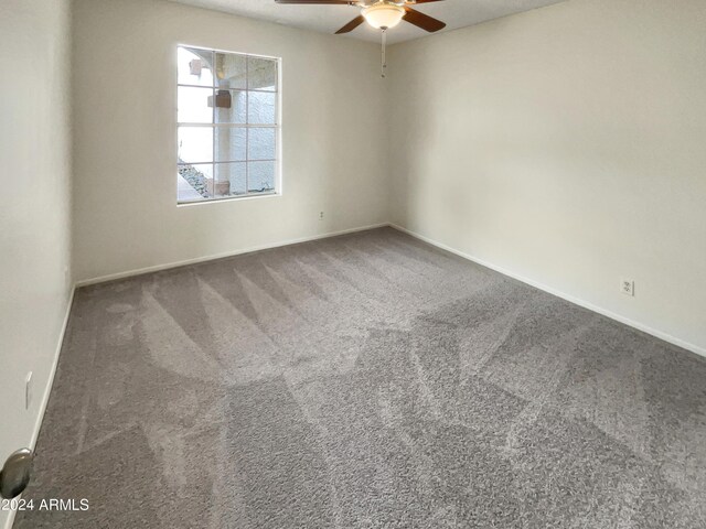 carpeted empty room featuring ceiling fan