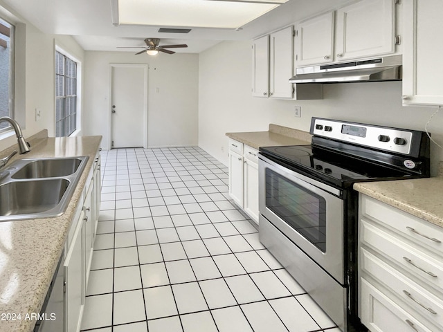 kitchen featuring stainless steel electric range oven, light countertops, under cabinet range hood, a sink, and light tile patterned flooring