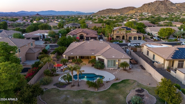 aerial view at dusk featuring a mountain view