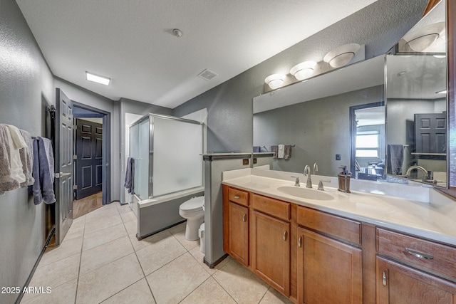 5303 N 7th St Unit 331, Phoenix, AZ 85014 - bathroom featuring a textured wall, vanity, tile patterned flooring, and enclosed tub / shower combo