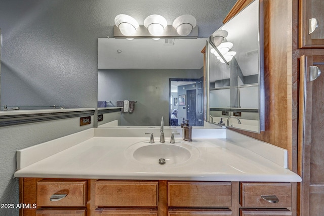 5303 N 7th St Unit 331, Phoenix, AZ 85014 - bathroom with vanity and a textured wall