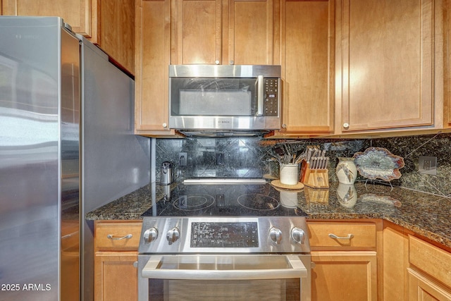 5303 N 7th St Unit 331, Phoenix, AZ 85014 - kitchen with appliances with stainless steel finishes, tasteful backsplash, and dark stone counters
