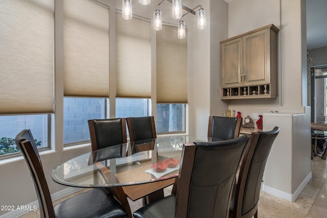 dining area with light tile flooring and plenty of natural light