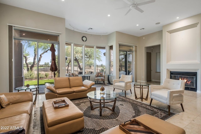 tiled living room featuring ceiling fan and a healthy amount of sunlight