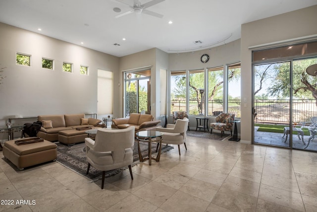 living room with light tile flooring, plenty of natural light, and ceiling fan