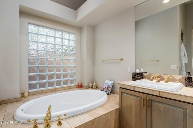 bathroom featuring tiled tub and oversized vanity