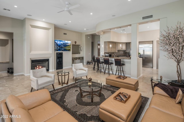 tiled living room featuring ceiling fan